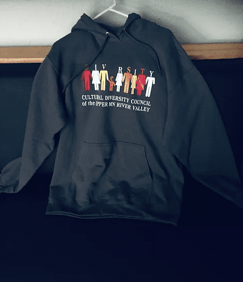 A black hoodie with a picture of people on it.