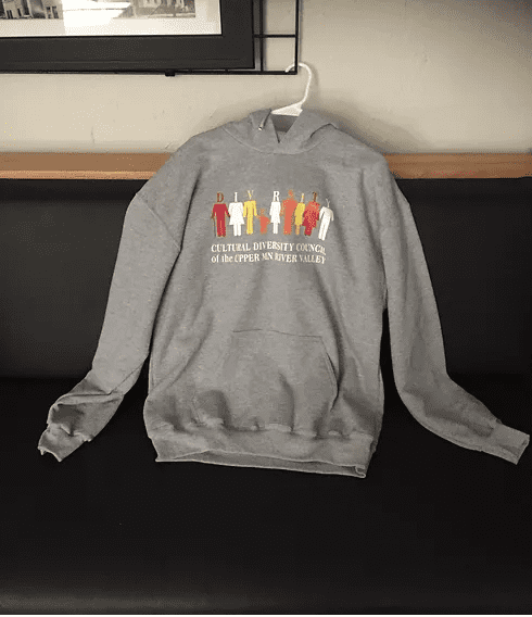 A sweatshirt hanging on the wall with a message.