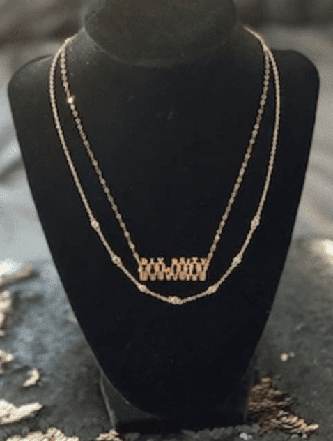A necklace is shown on display in front of a black background.