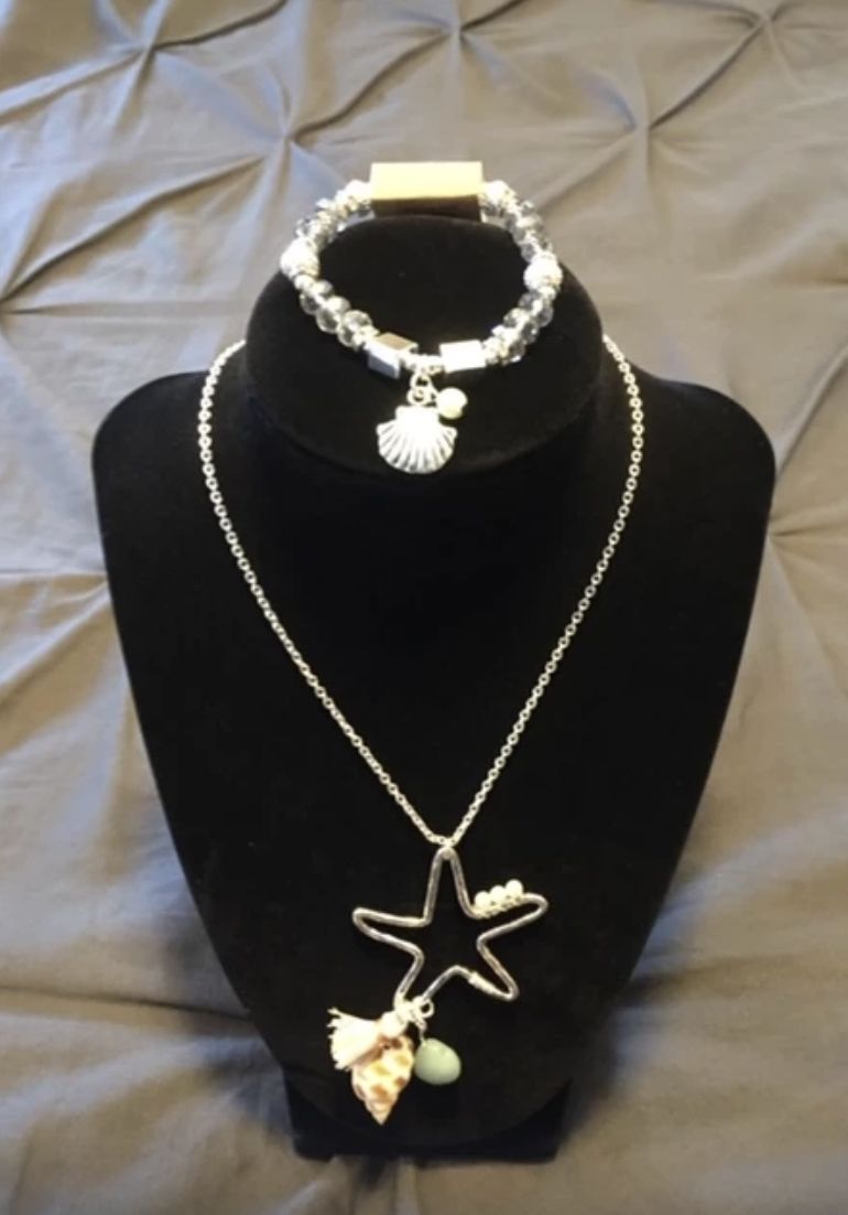 A necklace and bracelet on display in a store.