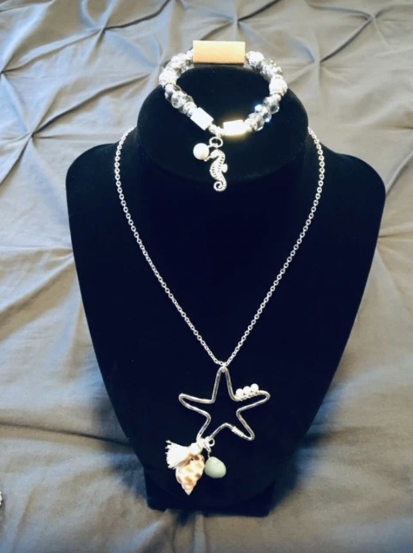 A necklace and bracelet on display in a store.